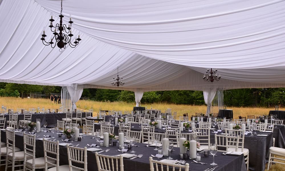 Decorated event tent with tables and chairs